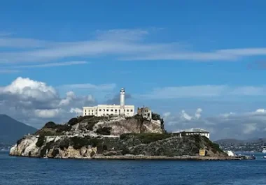 Alcatraz Island with historic white prison building and lighthouse in San Francisco Bay