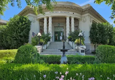 McHenry Museum historic building with white columns and green landscaping