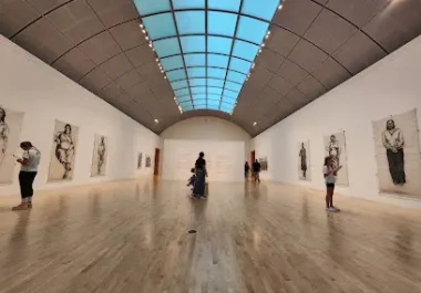 Modern art gallery with skylighted ceiling and framed artwork displays