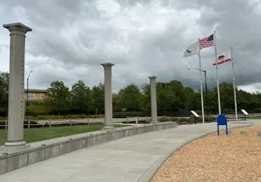 Six Pillars Park in San Ramon with columns, flags, and walking path