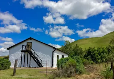 Rural barn with white exterior and metal staircase in Fremont, California countryside