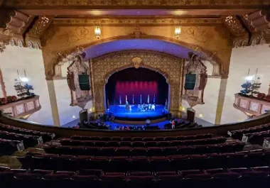Historic theater interior with stage lighting and ornate architecture in Stockton
